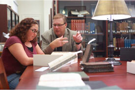 Student & Librarian researching in Special Collections