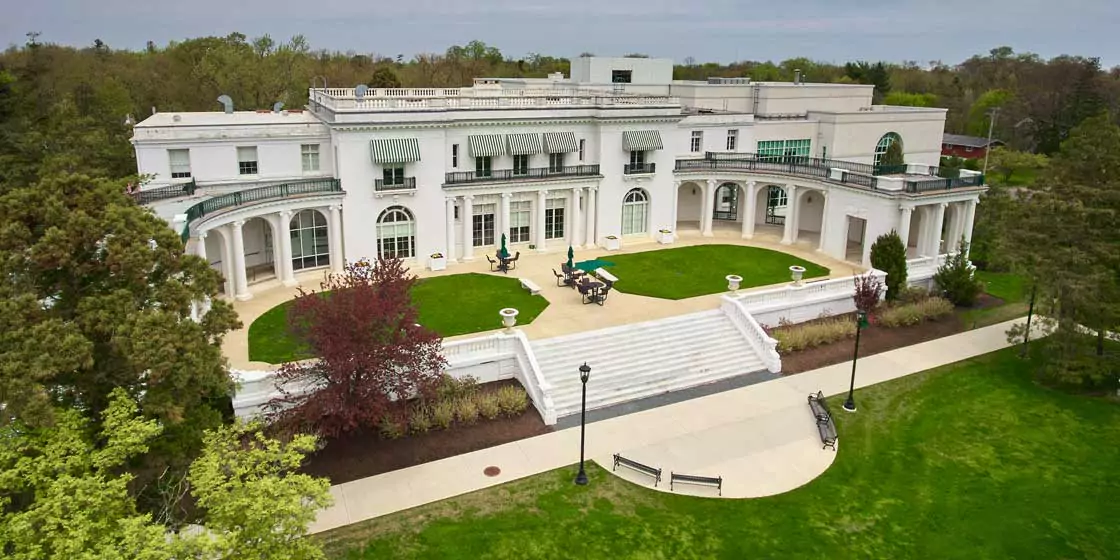 An arial photo of the Guggenheim library show the historic and sprwling mansion.